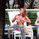 Jennifer Aniston sunbathing in bikini at her hotel in Miami Beach